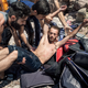 A group of Syrians help a fellow Syrian who was taken ill after he swam to reach the shore of the Greek island of Lesvos.